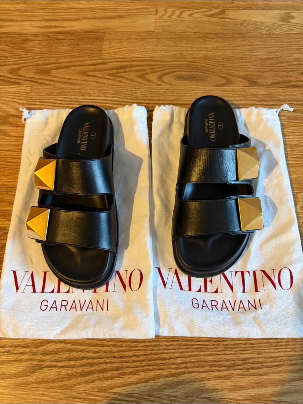 Valentino Garavani Black Leather Slides with Gold Pyramid Studs